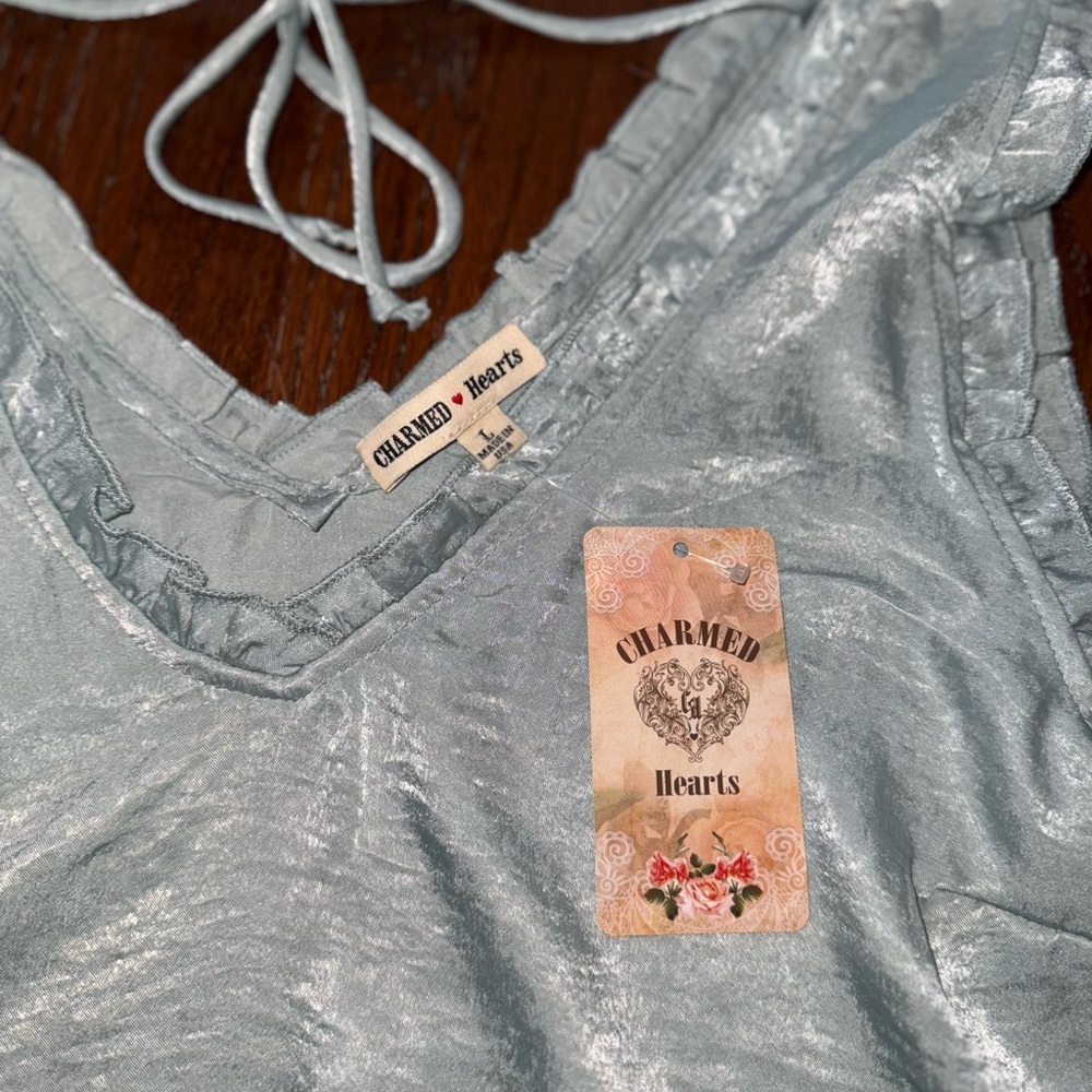 Charmed Hearts blue sleeveless top with ruffle around arm